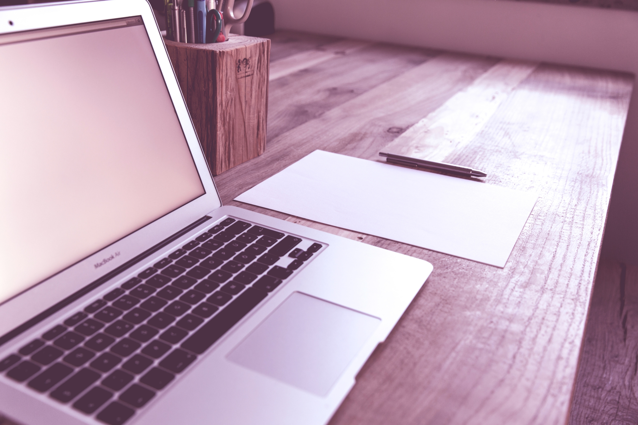 a laptop and a pen on a table