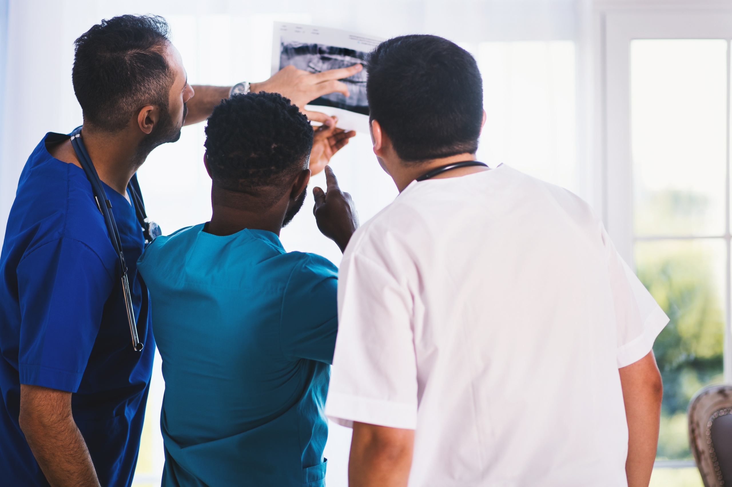 a group of men looking at a screen